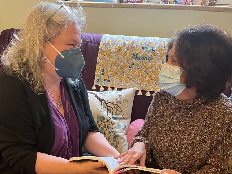 Two people read a resource together discussing options for menopause care